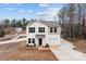 Two-story home with vinyl siding, an attached garage, and a spacious driveway set on a large lot at 2032 Country Pl, Hickory, NC 28601