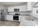 New kitchen with white cabinets, stainless steel appliances, granite countertops, and subway tile backsplash at 2032 Country Pl, Hickory, NC 28601