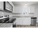 Bright kitchen featuring white cabinetry, stainless steel appliances, and granite countertops at 2032 Country Pl, Hickory, NC 28601