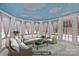 Inviting sunroom with cloud painted ceiling, wicker furniture and lots of natural light at 2032 Country Pl, Hickory, NC 28601