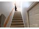 Carpeted stairway leading to the upper level with a white door at 2087 Serenity Ln, Rock Hill, SC 29730