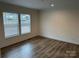 Bright bedroom featuring hardwood floors and large windows, offering a serene and inviting atmosphere at 238 Fairchase Cir # 54, Stony Point, NC 28678