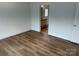 Cozy bedroom featuring wood floors, leading to an ensuite bathroom, for a private retreat at 238 Fairchase Cir # 54, Stony Point, NC 28678
