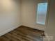 Neutral bedroom featuring hard surface floors and a window for natural light at 238 Fairchase Cir # 54, Stony Point, NC 28678