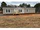 Charming single-story home featuring neutral siding, white-trimmed windows, and a welcoming front porch with wooden stairs at 238 Fairchase Cir # 54, Stony Point, NC 28678