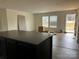 Well-lit kitchen overlooking a wooden deck outside, complete with a large dark island and modern blinds at 238 Fairchase Cir # 54, Stony Point, NC 28678