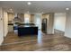 Spacious kitchen featuring a large island, stainless steel appliances, and hardwood flooring at 238 Fairchase Cir # 54, Stony Point, NC 28678