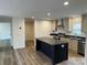 Open-concept kitchen with an island, stainless steel appliances, and seamless flow into the adjacent living area at 238 Fairchase Cir # 54, Stony Point, NC 28678