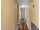 Hallway view featuring hardwood floors, neutral paint, and access to multiple rooms at 2410 Juniper Dr, Charlotte, NC 28269