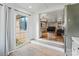 Open doorway showcases the spacious living room with hardwood floors from the adjacent kitchen at 2410 Juniper Dr, Charlotte, NC 28269