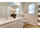 Bathroom with double sinks, white cabinets, and decorative floral arrangement at 2513 Crimson Way, Monroe, NC 28112