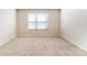 Bright bedroom with neutral carpet, offering a blank canvas for personalization with a large window at 2513 Crimson Way, Monroe, NC 28112