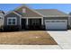 Charming single-story home showcasing a two-car garage, stone accents, neutral siding, and a well-maintained front yard at 2513 Crimson Way, Monroe, NC 28112