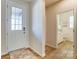 Inviting foyer with a front door and a view into a well-lit, modern bathroom with white fixtures at 2513 Crimson Way, Monroe, NC 28112