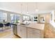 Open-concept kitchen flows into the living area, featuring an island with stainless steel sink at 2513 Crimson Way, Monroe, NC 28112