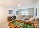 Relaxing living room with a comfortable couch, modern television, and fun foosball table for entertainment at 2513 Crimson Way, Monroe, NC 28112