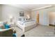 Bright main bedroom featuring a tray ceiling, sitting area and en-suite bathroom at 2513 Crimson Way, Monroe, NC 28112