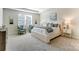 Comfortable main bedroom with a sitting area and a neutral color palette at 2513 Crimson Way, Monroe, NC 28112