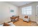 Well-lit home office with a desk, chair, and a cozy armchair, perfect for a productive workspace at 2513 Crimson Way, Monroe, NC 28112