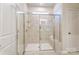 Modern bathroom with a luxurious glass-enclosed shower and marble tile surround at 2513 Crimson Way, Monroe, NC 28112