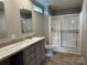 A clean bathroom with a single sink vanity, a glass shower, and neutral-colored walls at 252 Fairchase Cir # 56, Stony Point, NC 28678