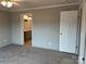 Spacious bedroom with an attached bathroom, carpet floors, and neutral-colored walls at 252 Fairchase Cir # 56, Stony Point, NC 28678