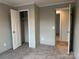 Bedroom showcasing closet, neutral carpet, and view to hallway at 252 Fairchase Cir # 56, Stony Point, NC 28678