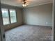 A cozy bedroom with carpet floors, two large windows, and neutral-colored walls at 252 Fairchase Cir # 56, Stony Point, NC 28678