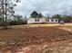 Single-story home with a covered front porch and green shutters on a large lot at 252 Fairchase Cir # 56, Stony Point, NC 28678