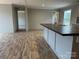 Modern kitchen island with a large sink, hardwood floors, and natural light at 252 Fairchase Cir # 56, Stony Point, NC 28678