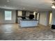Open concept view of the kitchen island with modern appliances and grey cabinets at 252 Fairchase Cir # 56, Stony Point, NC 28678