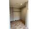 Functional laundry room with wood-look floors, overhead shelf, and neutral walls at 252 Fairchase Cir # 56, Stony Point, NC 28678