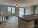 Bright living room featuring a ceiling fan, windows, and an open doorway at 252 Fairchase Cir # 56, Stony Point, NC 28678