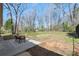 Spacious backyard featuring a patio with table and chairs and a black chain-link fence at 2537 Wood Star Ct, Matthews, NC 28105