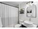 Modern bathroom with decorative light fixtures, black accents, updated shower and sink at 2537 Wood Star Ct, Matthews, NC 28105