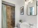 Bathroom featuring a tiled shower, updated fixtures, and a decorative mirror at 2537 Wood Star Ct, Matthews, NC 28105