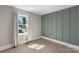 Bright bedroom with green paneling and a large window with a view of the yard at 2537 Wood Star Ct, Matthews, NC 28105