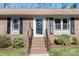 Close-up of front door with wreath, black shutters, and brick steps at 2537 Wood Star Ct, Matthews, NC 28105