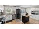 Bright kitchen featuring white cabinets, stainless steel appliances, and a mobile island at 2537 Wood Star Ct, Matthews, NC 28105