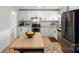 Bright kitchen with white cabinets, granite countertops, stainless steel appliances, and a butcher block island at 2537 Wood Star Ct, Matthews, NC 28105