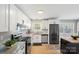 Modern kitchen with stainless steel appliances, white cabinets, granite countertops, and natural light at 2537 Wood Star Ct, Matthews, NC 28105