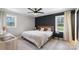 Bedroom with a black accent wall, wood-look floors, a ceiling fan and bright windows at 2537 Wood Star Ct, Matthews, NC 28105
