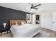 Bedroom features dark accent wall, wood-look floors, ceiling fan and a view of the closet at 2537 Wood Star Ct, Matthews, NC 28105