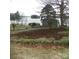 View of backyard with sheds and a lake in the background, perfect for outdoor activities and relaxation at 254 N Shoreline N Dr # 38, New London, NC 28127
