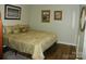 A traditionally decorated bedroom with patterned bedding on top of wooden floors at 254 N Shoreline N Dr # 38, New London, NC 28127