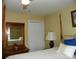 A four-poster bed is featured in this bedroom with a light yellow color scheme and a dressing table at 254 N Shoreline N Dr # 38, New London, NC 28127