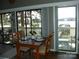 Dining area with sliding glass doors leading to a patio with waterfront views at 254 N Shoreline N Dr # 38, New London, NC 28127