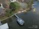 Aerial view of a private boat dock on the water, offering direct access to the lake at 254 N Shoreline N Dr # 38, New London, NC 28127