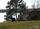 Picturesque waterfront property featuring a charming house, shed, and dock, ideal for lakeside enjoyment at 254 N Shoreline N Dr # 38, New London, NC 28127