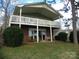 Back exterior of home with spacious deck, patio and beautiful yard, great for outdoor living at 254 N Shoreline N Dr # 38, New London, NC 28127